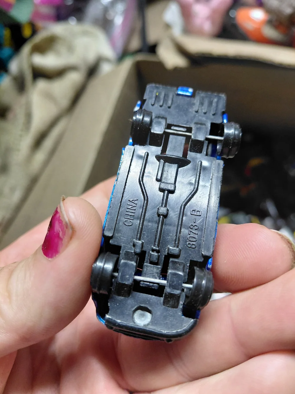 blue diecast pickup truck is a 1:64 scale model, possibly from a 